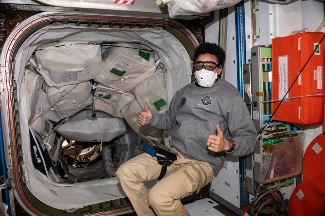Expedition 67 Flight Engineer and NASA astronaut Jessica Watkins wears personal protective equipment (PPE) as a precaution before entering the SpaceX Dragon resupply ship a couple of hours after it docked to the Harmony module's forward port on the International Space Station. The PPE prevents a crew member from inadvertently coming in contact with dust and other atmospheric particles that may have dislodged inside the vehicle during its launch and ascent into Earth orbit.