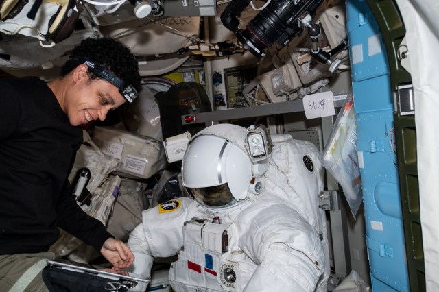 NASA astronaut and Expedition 67 Flight Engineer Jessica Watkins works on U.S. spacesuit helmet light components inside the Quest airlock aboard the International Space Station.