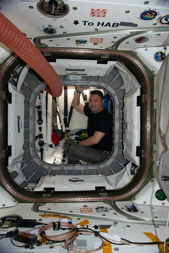NASA astronaut and Expedition 67 Flight Engineer Kjell Lindgren is pictured inside the vestibule between the Unity module and the Cygnus space freighter finalizing cargo operations the day before the vehicle's departure from the International Space Station.