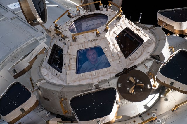NASA astronaut and Expedition 67 Flight Engineer Kjell Lindgren is pictured looking out from a window on the cupola, the International Space Station's "window to the world." The astronauts use the seven-windowed cupola to monitor the arrival of spaceships at the orbiting lab and view the Earth below.