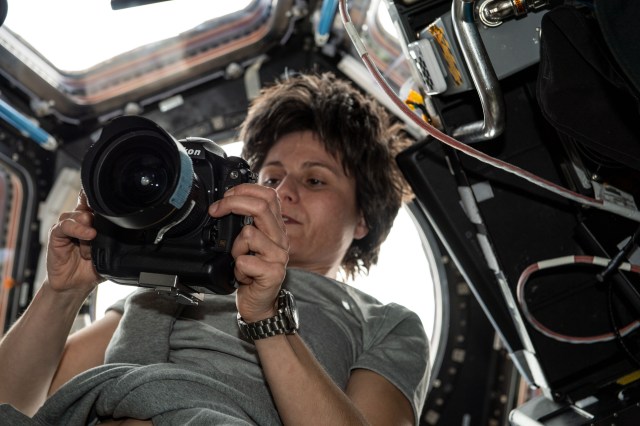 ESA (European Space Agency) astronaut and Expedition 67 Flight Engineer Samantha Cristoforetti checks out a camera inside the International Space Station's "window to the world," the seven-windowed cupola.