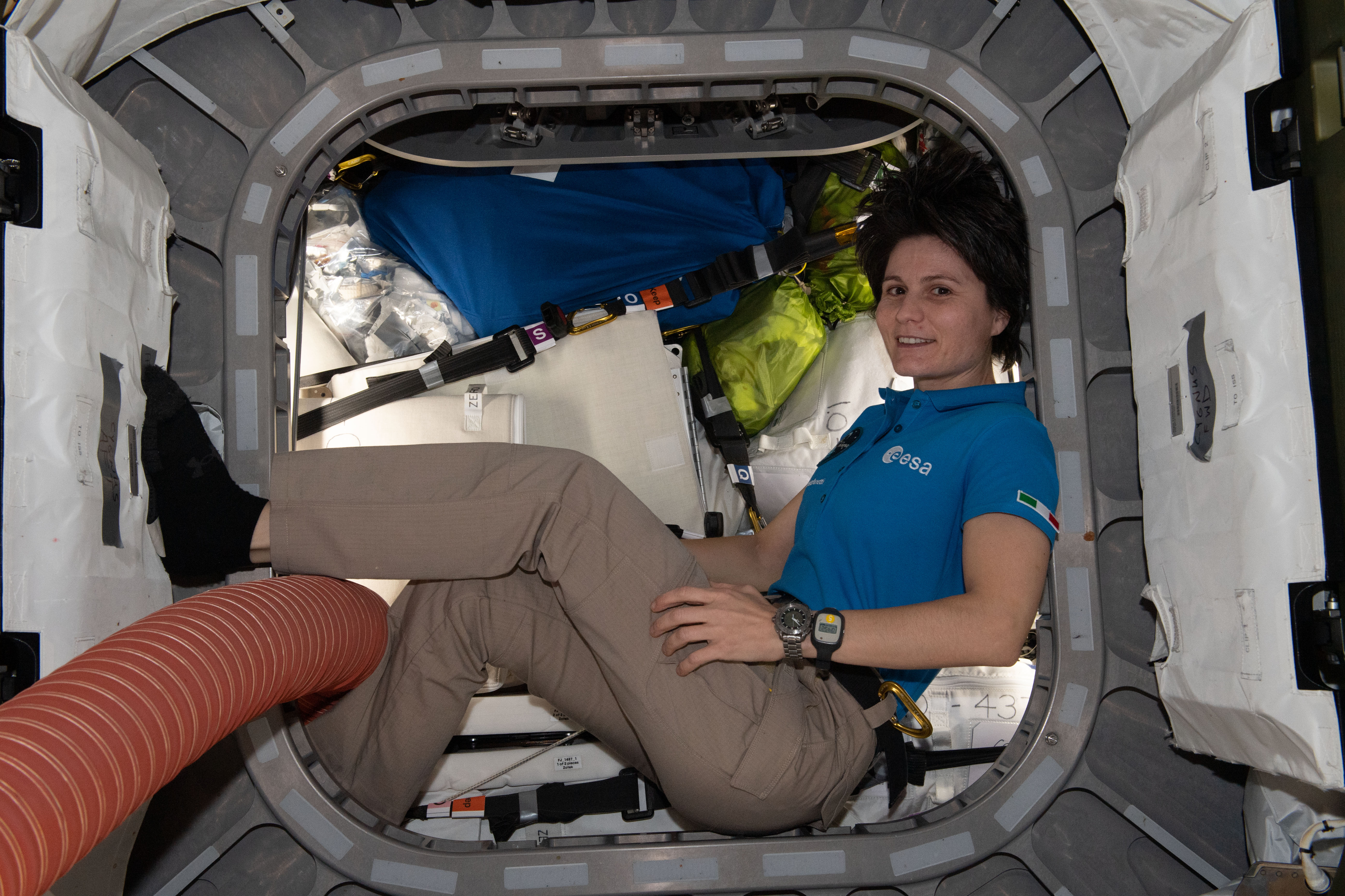 ESA (European Space Agency) astronaut and Expedition 67 Flight Engineer Samantha Cristoforetti is pictured inside the vestibule between the Unity module and the Cygnus space freighter finalizing cargo operations the day before the vehicle's departure from the International Space Station.