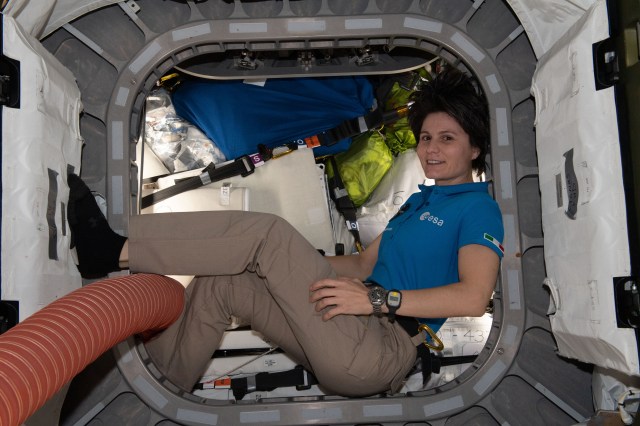 ESA (European Space Agency) astronaut and Expedition 67 Flight Engineer Samantha Cristoforetti is pictured inside the vestibule between the Unity module and the Cygnus space freighter finalizing cargo operations the day before the vehicle's departure from the International Space Station.