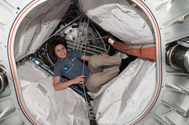 Expedition 67 Flight Engineer and ESA (European Space Agency) astronaut Samantha Cristoforetti is pictured inside the Bigelow Expandable Activity Module (BEAM) swapping batteries inside its sensor systems.