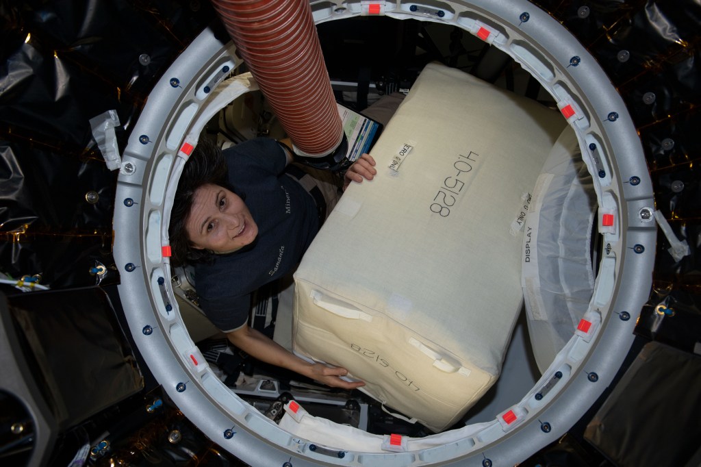 ESA (European Space Agency) astronaut and Expedition 67 Flight Engineer Samantha Cristoforetti is pictured packing cargo inside the SpaceX Dragon resupply ship before it undocked from the International Space Station on Aug. 19, 2022.