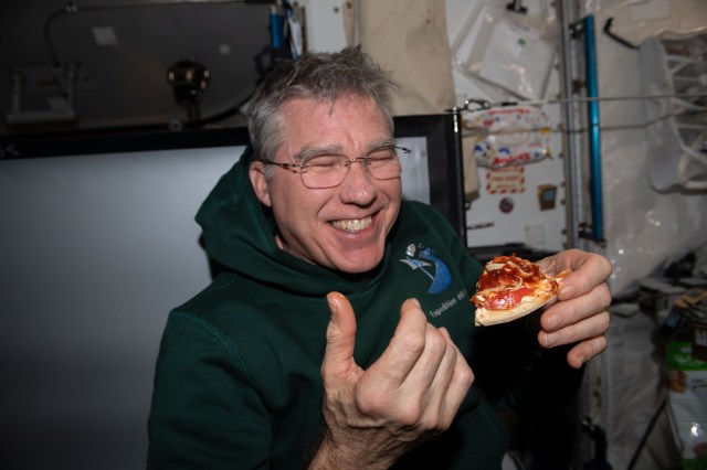 NASA astronaut and Expedition 69 Flight Engineer Stephen Bowen is pictured in the International Space Station's Unity module during the always popular pizza night.
