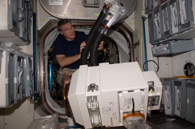 NASA astronaut and Expedition 69 Flight Engineer Stephen Bowen is pictured inside the International Space Station's Unity module after unpacking life support hardware from inside Northrop Grumman's Cygnus space freighter.