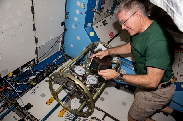 NASA astronaut and Expedition 69 Flight Engineer Stephen Bowen works on life support hardware inside the International Space Station's Destiny laboratory module.
