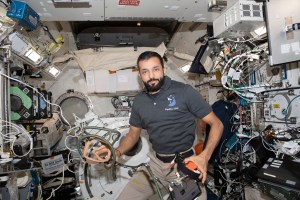 UAE (United Arab Emirates) astronaut and Expedition 69 Flight Engineer Sultan Alneyadi is pictured holding portable breathing gear inside the International Space Station's Kibo laboratory module.