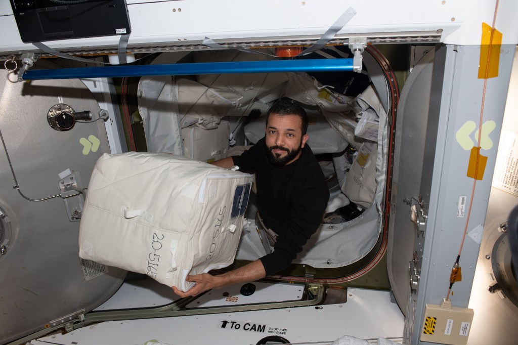 UAE (United Arab Emirates) astronaut and Expedition 69 Flight Engineer Sultan Alneyadi begins unloading cargo from the SpaceX Dragon cargo vehicle shortly after it docked to the International Space Station on June 6, 2023.
