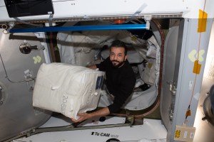 UAE (United Arab Emirates) astronaut and Expedition 69 Flight Engineer Sultan Alneyadi begins unloading cargo from the SpaceX Dragon cargo vehicle shortly after it docked to the International Space Station on June 6, 2023.