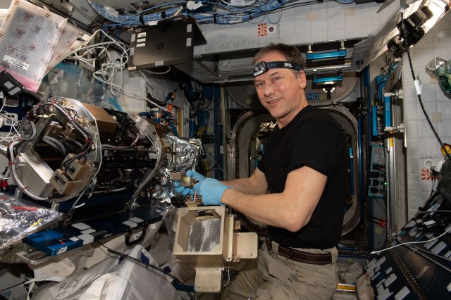 NASA astronaut and Expedition 67 Commander Thomas Marshburn configures the Combustion Integrated Rack's combustion chamber for the Solid Fuel Ignition and Extinction study to investigate material flammability and ways to improve fire safety in space.
