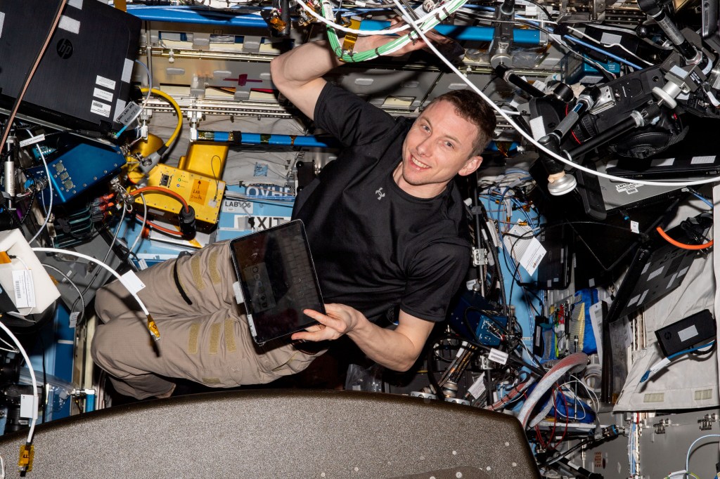 NASA astronaut and Expedition 69 Flight Engineer Woody Hoburg is pictured inside the Destiny laboratory module installing electronics and communications hardware.