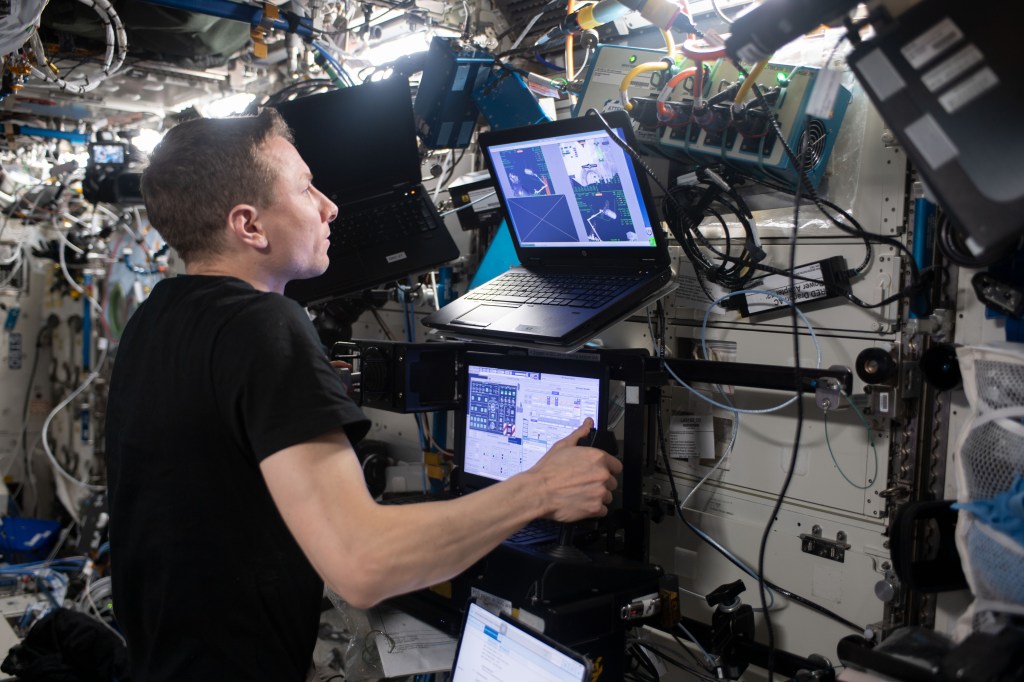 NASA astronaut and Expedition 69 Flight Engineer Woody Hoburg participates in robotics proficiency training using the Destiny laboratory module's robotics workstation aboard the International Space Station.