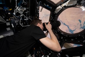 NASA astronaut and Expedition 69 Flight Engineer Woody Hoburg is pictured inside the seven window cupola photographing Lake Nasser in Egypt as the International Space Station orbited 257 miles above.
