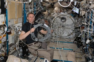 NASA astronaut and Expedition 69 Flight Engineer Woody Hoburg reconfigures video cables belonging to the Kibo laboratory module's Cell Biology Experiment Facility, a research incubator that generates artificial gravity.