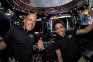 NASA astronauts Bob Hines and Jessica Watkins are pictured inside the cupola, the International Space Station's "window to the world," after monitoring the successful rendezvous and docking of the SpaceX Dragon space freighter on its 25th Commercial Resupply Services mission.