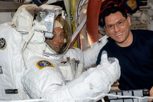 iss069e017126 (June 2, 2023) --- NASA astronaut Frank Rubio (right) assists NASA astronaut Woody Hoburg during a fit check of his spacesuit inside the International Space Station's Quest airlock.