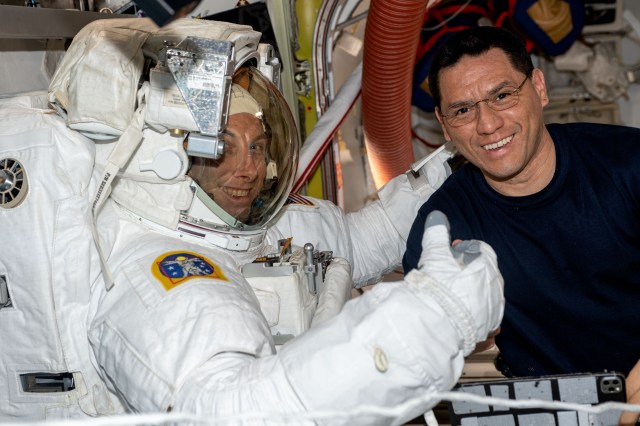 iss069e017126 (June 2, 2023) --- NASA astronaut Frank Rubio (right) assists NASA astronaut Woody Hoburg during a fit check of his spacesuit inside the International Space Station's Quest airlock.