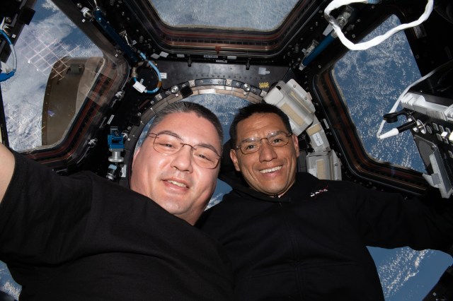 Expedition 67 Flight Engineers (from left) Kjell Lindgren and Frank Rubio, both NASA astronauts, pose for a portrait together inside the cupola, the International Space Station's "window to the world."