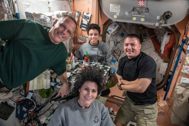(Clockwise from left) Expedition 67 Flight Engineers Bob Hines, Jessica Watkins, and Kjell Lindgren, all from NASA, and Samantha Cristoforetti from ESA (European Space Agency), pose for a portrait during dinner time in the Unity module of the International Space Station.