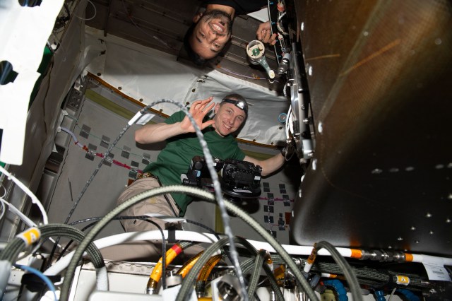 Expedition 69 Flight Engineers (from top) Sultan Alneyadi of UAE (United Arab Emirates) and Woody Hoburg of NASA are pictured inside the Tranquility module working on life support maintenance tasks aboard the International Space Station.
