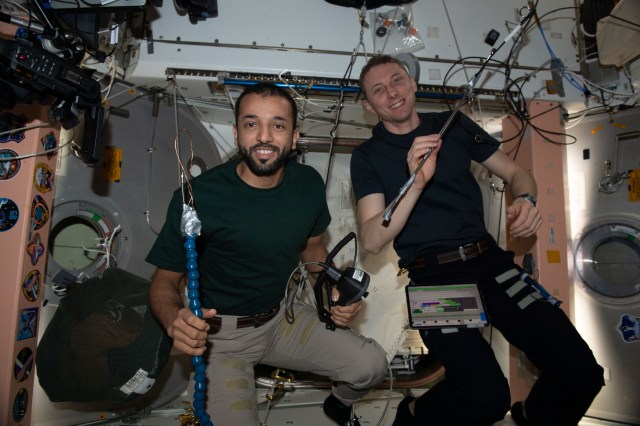 Expedition 69 Flight Engineers Sultan Alneyadi of UAE (United Arab Emirates) and Woody Hoburg of NASA are pictured showing off the tools they used to successfully open a hatch on the Unity module's space-facing side.