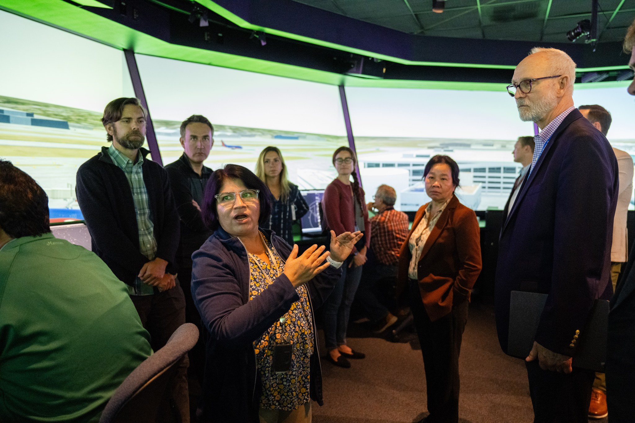 Savvy Verma and Huy Tran, director of aeronautics at NASA’s Ames Research Center in California’s Silicon Valley, explain a recent air traffic management simulation to guest at Ames’ FutureFlight Central simulator on Sept. 26.
