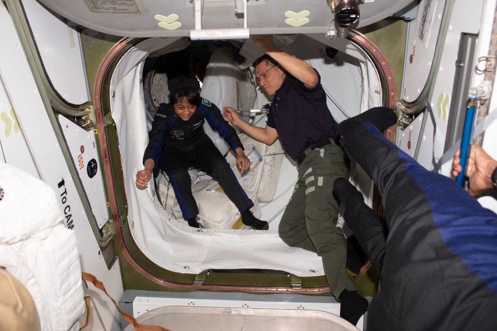 Axiom Space private astronaut and Axiom Mission-2 Mission Specialist Rayyanah Barnawi enters the International Space Station shortly after the hatches were opened between the orbital outpost and the SpaceX Dragon Freedom spacecraft. Welcoming her inside the vestibule between the station's Harmony module and Dragon is NASA astronaut and Expedition 69 Flight Engineer Frank Rubio.