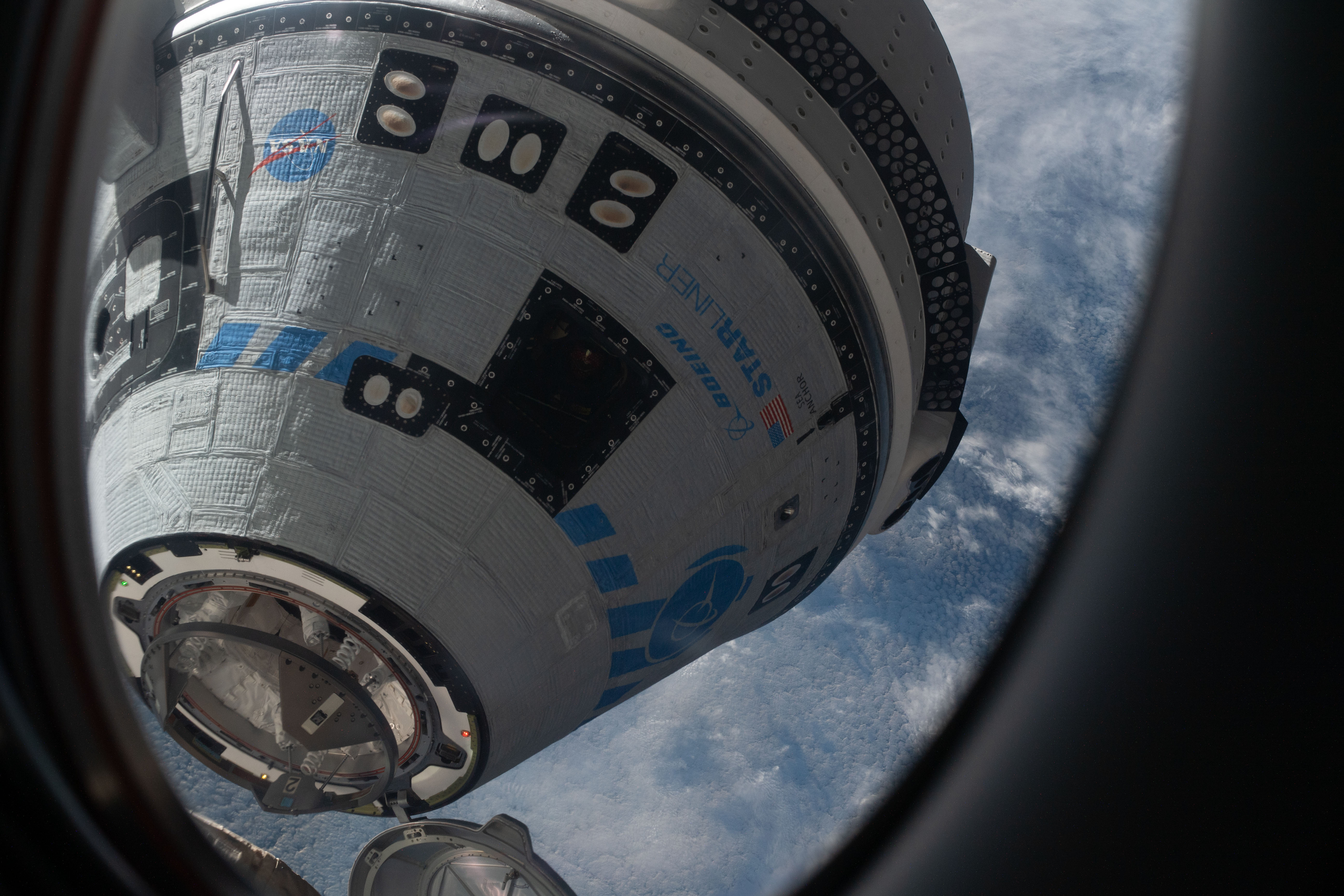 This view from a window on the SpaceX Crew Dragon Freedom crew ship shows Boeing's CST-100 Starliner crew ship moments away from docking to the Harmony module's forward port on the International Space Station for the company's Orbital Flight Test-2 mission.