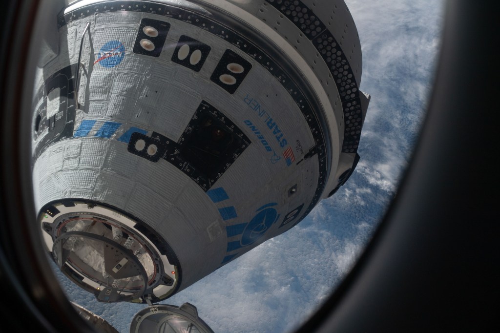 This view from a window on the SpaceX Crew Dragon Freedom crew ship shows Boeing's CST-100 Starliner crew ship moments away from docking to the Harmony module's forward port on the International Space Station for the company's Orbital Flight Test-2 mission.