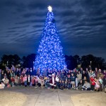 Marshall team members and their family members smile cheerfully as they pose in front of the tree after it was lit. “The holiday season is such a special time for so many people,” Pelfrey said. “To see all the Marshall team members out celebrating with their kids makes for a special day. It was really great to see.”