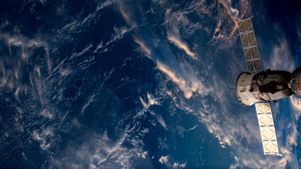 Clouds are painted pink and white at orbital sunrise as the International Space Station orbited 259 miles above the coast of Guatemala. The Soyuz MS-23 spacecraft docked to the station's Prichal module can be seen to the right of the image.