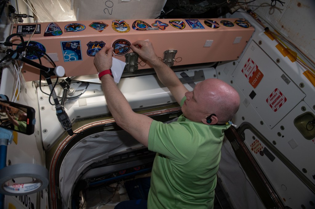 Expedition 67 Commander Oleg Artemyev affixes his mission's insignia sticker to the inside of the International Space Station's Unity module. Artemyev, along with Roscosmos Flight Engineers Denis Matveev and Sergey Korsakov, would depart the orbiting lab on Sept. 29 inside the Soyuz MS-21 crew ship for a parachute-assisted landing in Kazakhstan ending a six-month space research mission.