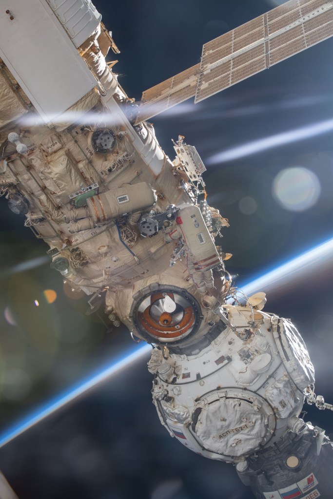 Roscosmos cosmonauts Oleg Artemyev and Denis Matveev are pictured attached to the Nauka multipurpose laboratory module during a seven-hour and 42-minute spacewalk to activate the European robotic arm on the International Space Station.
