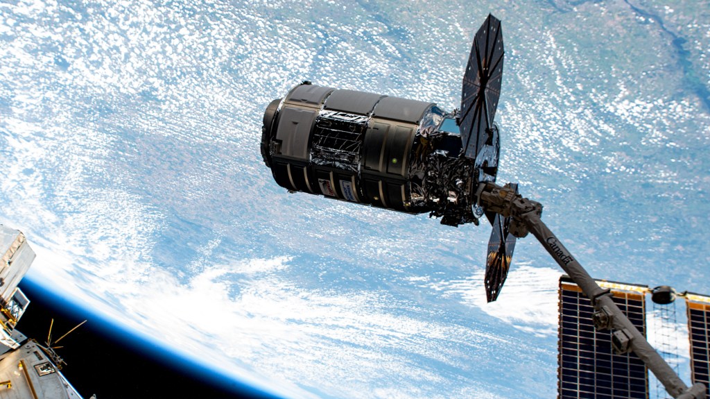 Northrop Grumman's Cygnus cargo craft is pictured moments after it was captured by the Canadarm2 robotic arm controlled by NASA astronaut and Expedition 69 Flight Engineer Woody Hoburg from inside the International Space Station.