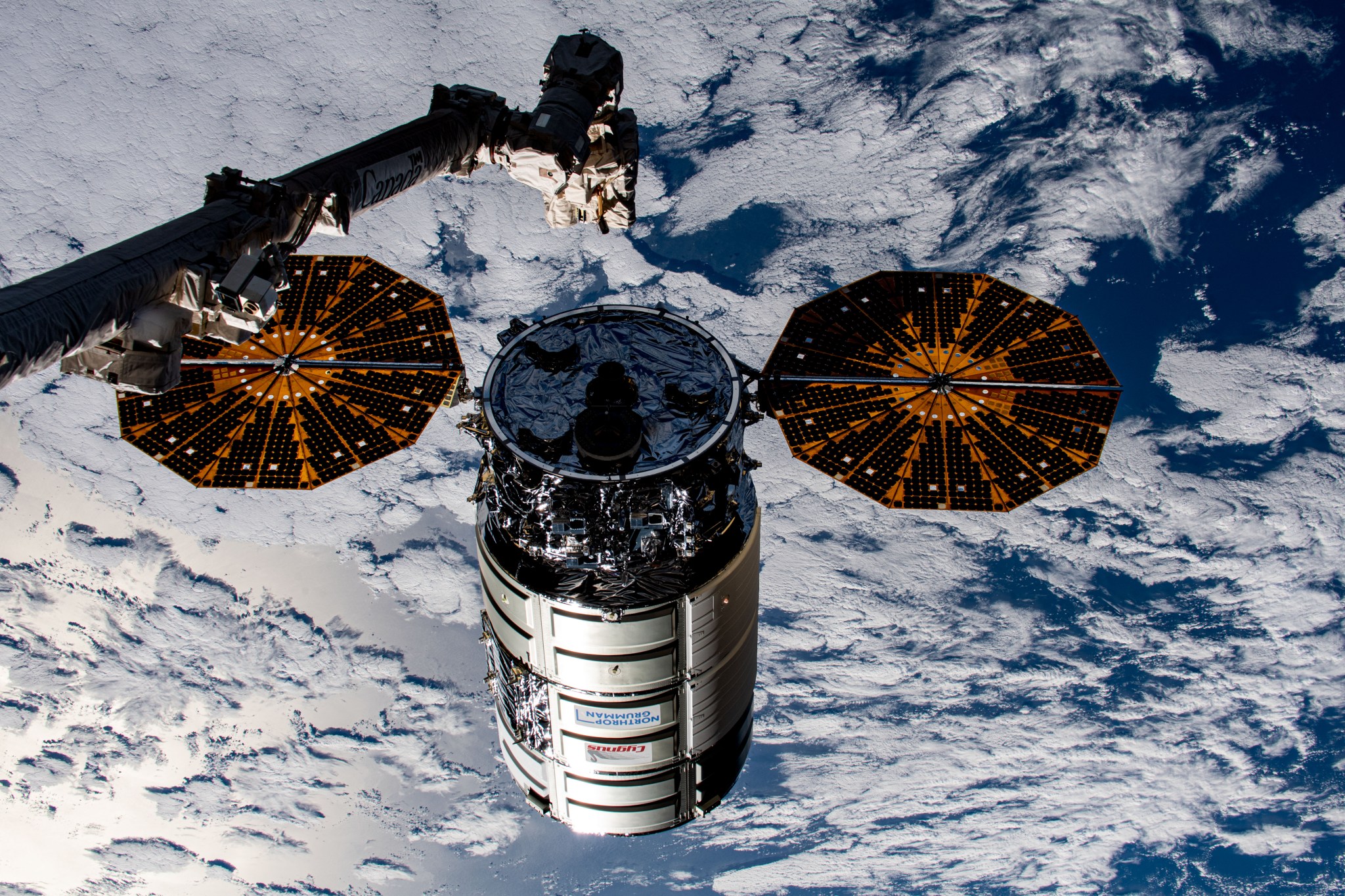 Northrop Grumman's Cygnus cargo craft is pictured moments away from being captured by the Canadarm2 robotic arm controlled by NASA astronaut and Expedition 69 Flight Engineer Woody Hoburg from inside the International Space Station.