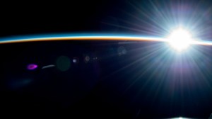 Earth's atmosphere glimmers in this photograph from the International Space Station as it soars into a radiant orbital sunrise 257 miles above the Pacific Ocean.