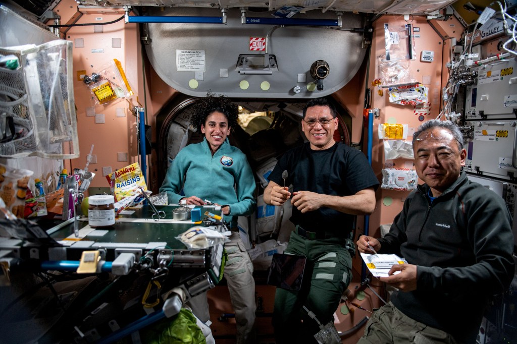 Expedition 69 Flight Engineers (from left) Jasmin Moghbeli and Frank Rubio, both from NASA, and Satoshi Furukawa of JAXA (Japan Aerospace Exploration Agency) join each other for lunch aboard the International Space Station's Unity module.