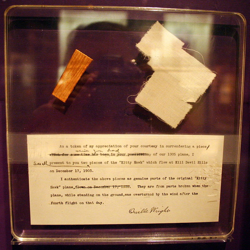 Display of the pieces of wood and fabric from the Wright Flyer that launched on space shuttle Challenger’s STS-51L mission and recovered from the wreckage