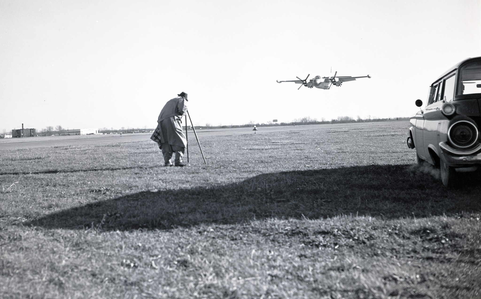 Photographer filming low flying aircraft.