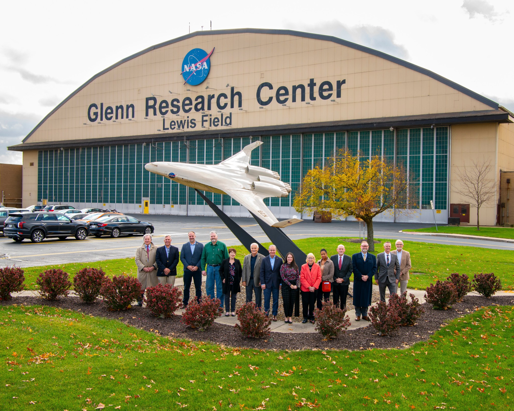 Members of the Northeast Ohio Mayors and City Managers Association pose in front of an airplane model by NASA Glenn Research Center’s hangar.