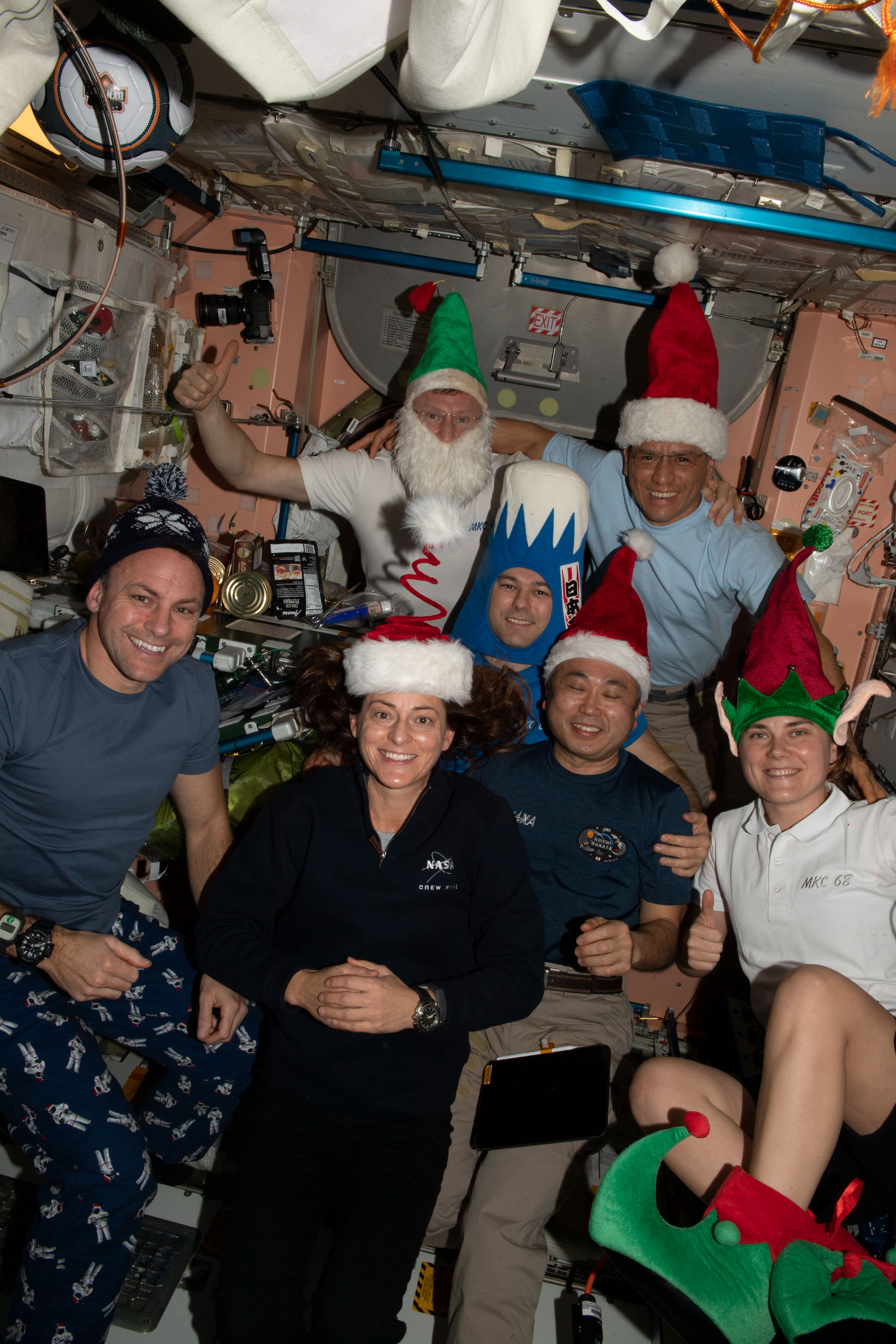 Expedition 68 crew members wear holiday garb