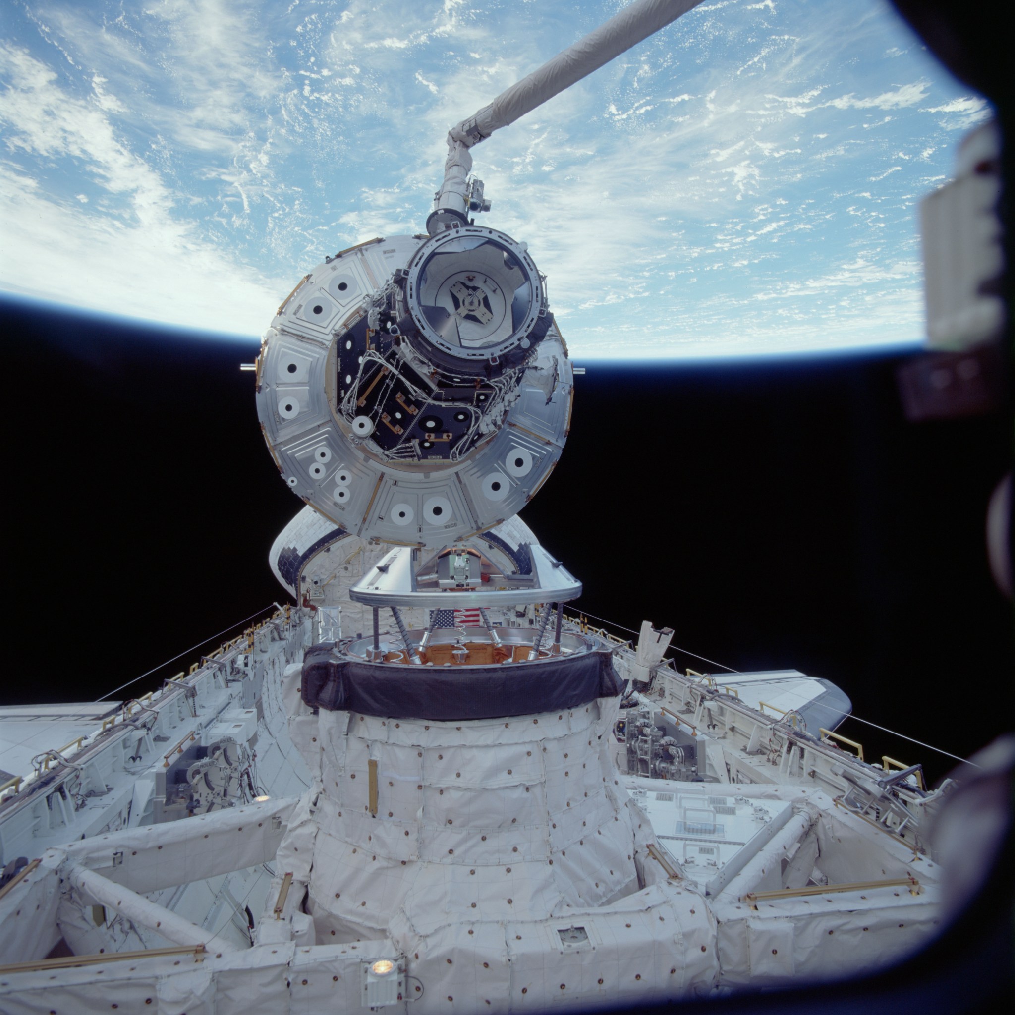 Image of the Unity Node 1 module being lifted out of the cargo bay