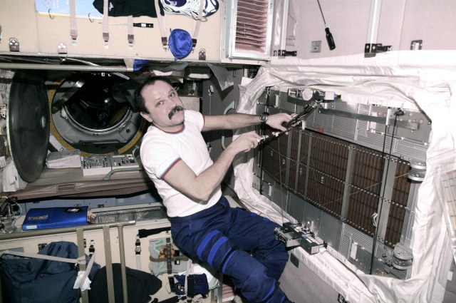 Cosmonaut Yury V. Usachev, Expedition Two mission commander, performs routine maintenance on the International Space Station's (ISS) Treadmill Vibration Isolation System (TVIS) in the Zvezda / Service Module. This image was recorded with a digital still camera.