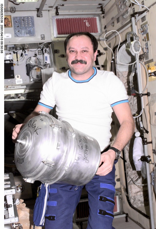 As part of routine procedures, cosmonaut Yury V. Usachev, Expedition Two mission commander, changes out a solid waste container in the Zvezda / Service Module. This image was recorded with a digital still camera.