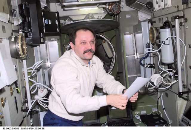 Cosmonaut Yury V. Usachev, Expedition Two commander, looks over a document in the Zvezda Service Module on the International Space Station (ISS). The Rosaviakosmos cosmonaut and two astronauts are in the early stages of a lengthy stay aboard the orbiting outpost. The image was recorded with a digital still camera.