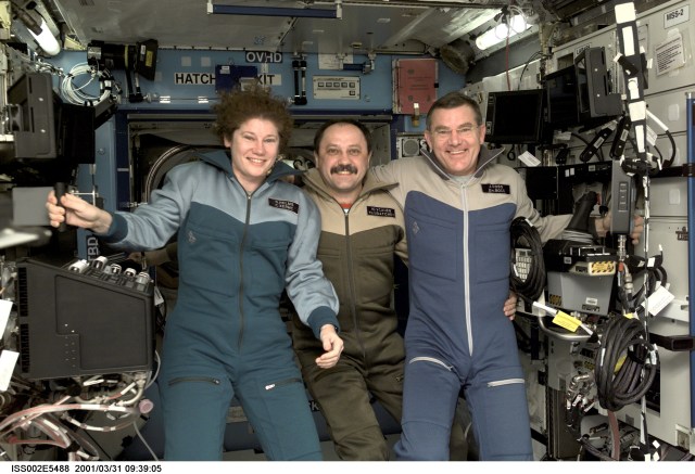 The Expedition Two crew members -- astronaut Susan J. Helms (left), cosmonaut Yury V. Usachev and astronaut James S. Voss -- pose for a photograph in the U.S. Laboratory / Destiny module of the International Space Station (ISS). This image was recorded with a digital still camera.