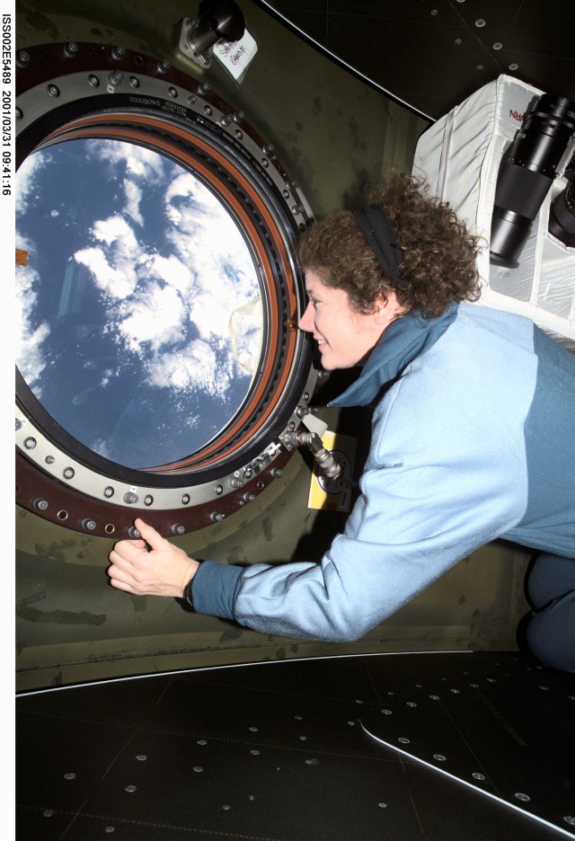 Astronaut Susan J. Helms, Expedition Two flight engineer, views the topography of a point on Earth from the nadir window in the U.S. Destiny laboratory module of the International Space Station (ISS). The image was recorded with a digital still camera.