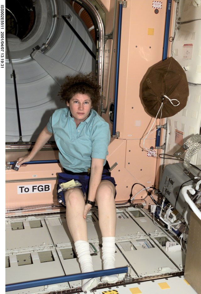 Astronaut Susan J. Helms, Expedition Two flight engineer, pauses from moving through the Node 1 / Unity module of the International Space Station (ISS) to pose for a photograph. This image was recorded with a digital still camera.